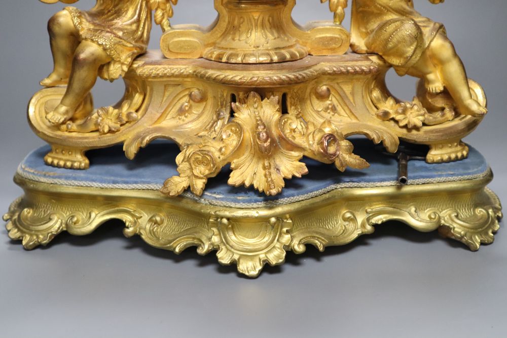 A 19th century French ormolu and gilt metal mantel clock, with musical youth surmount, Vincenti bell striking movement, on giltwood pli